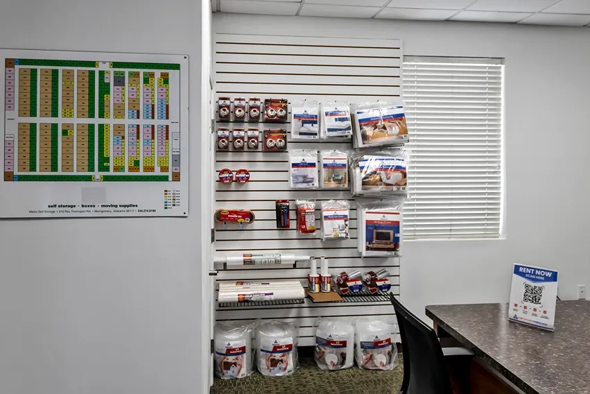 Storage office interior with moving supplies, packing materials, and facility layout map